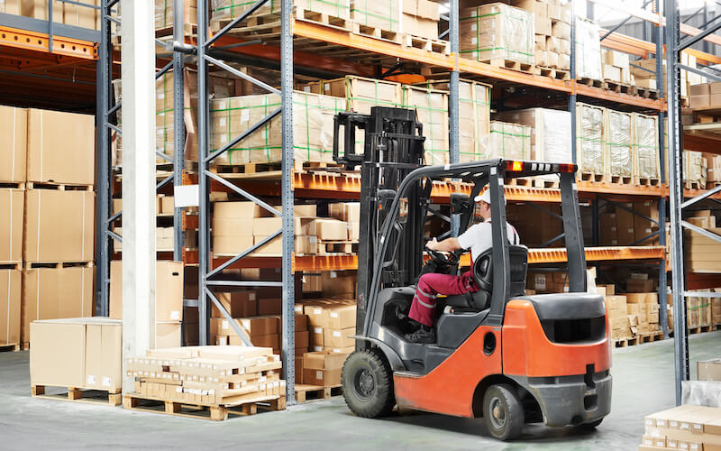 worker driver at warehouse forklift loader works