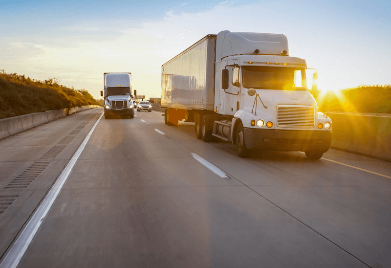 semi trucks driving down the highway