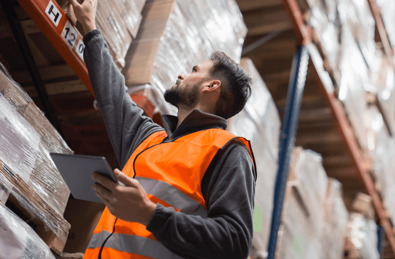worker taking inventory in warehouse