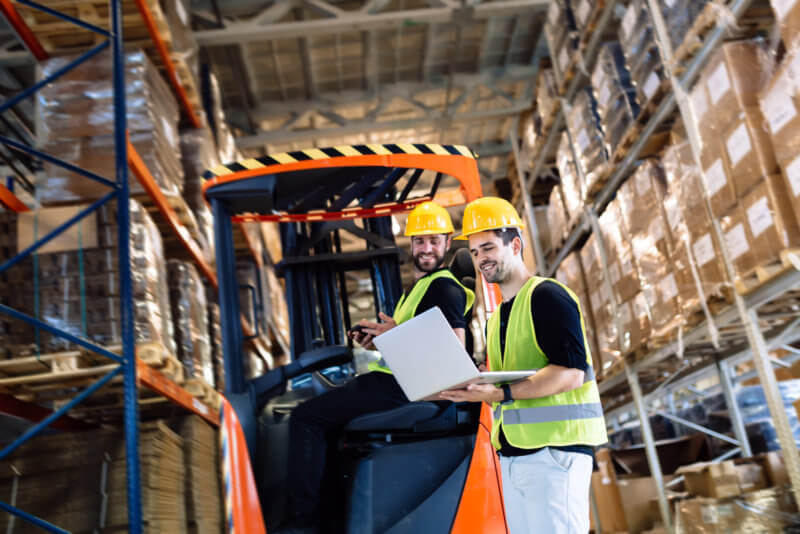 forklift worker talking with boss using laptop